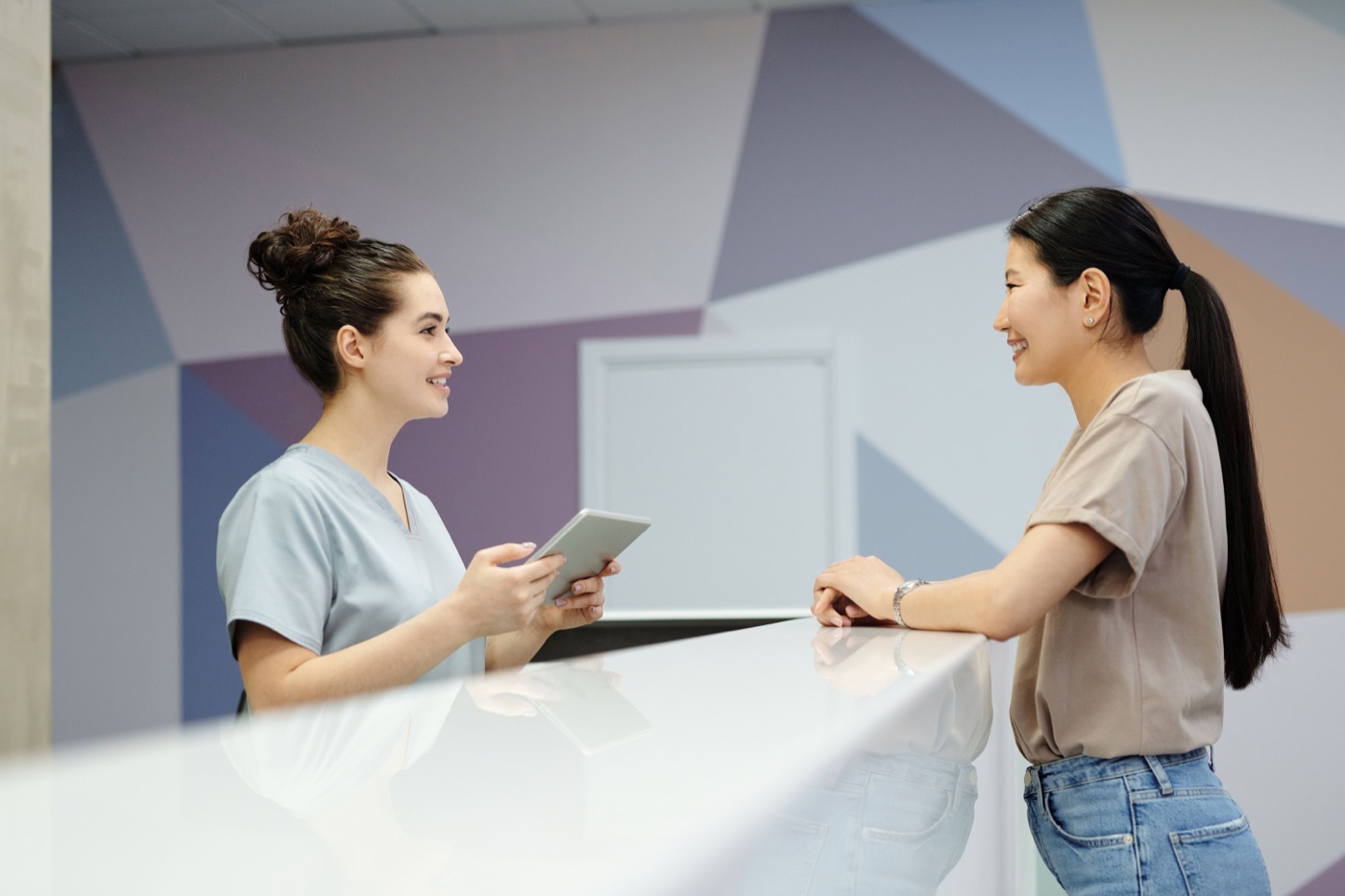 Clinic staff member welcoming a visitor